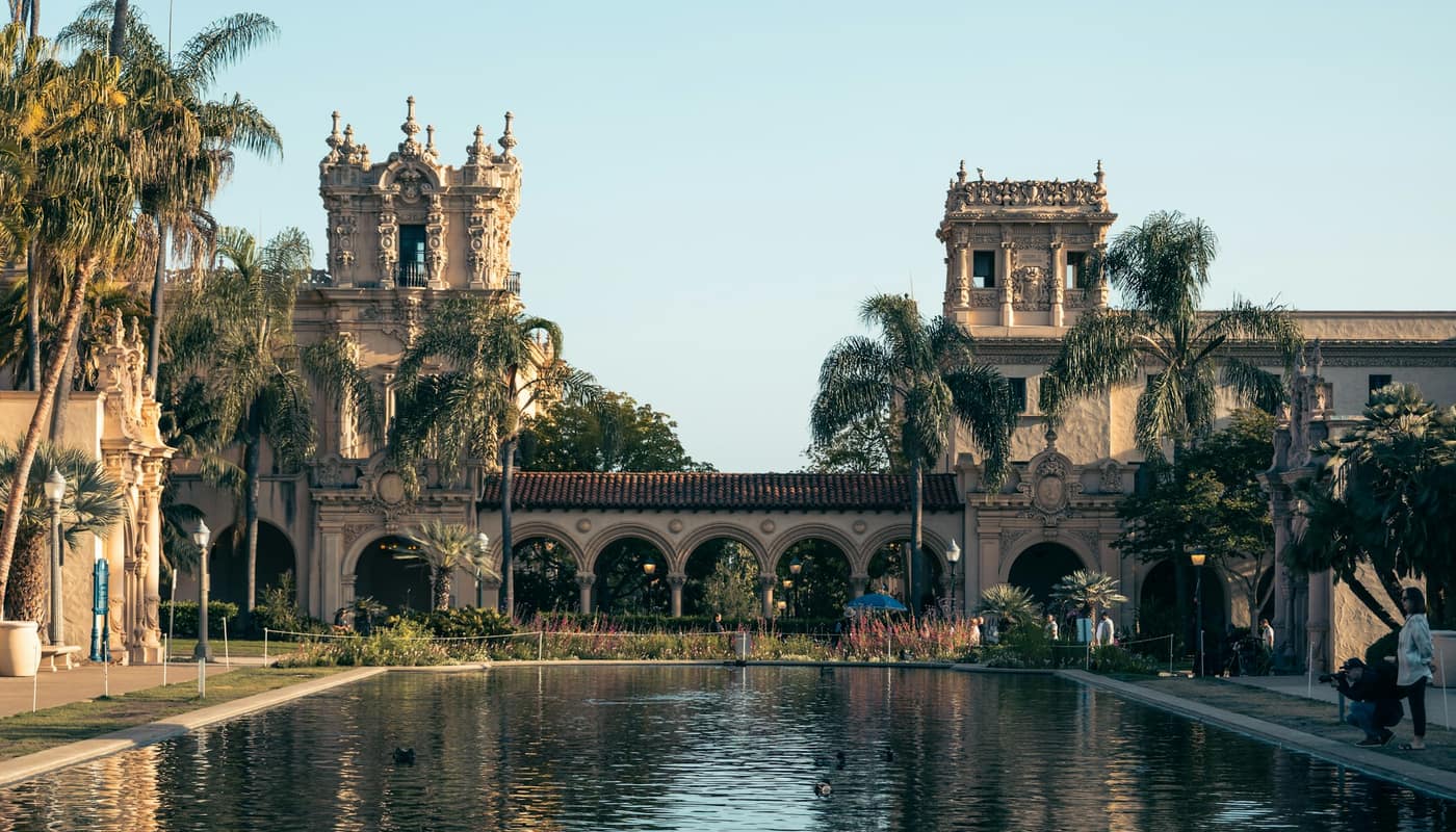 Spanish Colonial Revival architecture with palm trees in a park